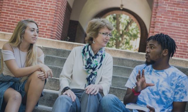 Students and faculty talk on the steps of Beloit College.